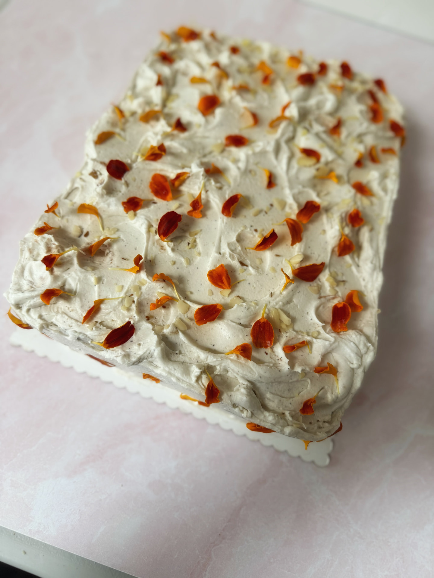 9x13 sheet cake with frosting and edible flower petals